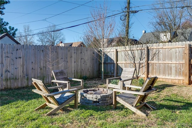 view of yard featuring a fire pit and a fenced backyard