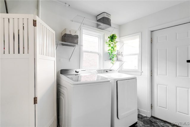 clothes washing area with laundry area and separate washer and dryer