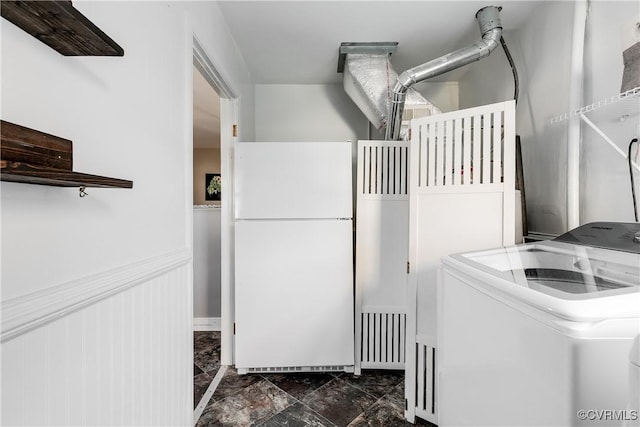 washroom with washer / dryer, wainscoting, and laundry area