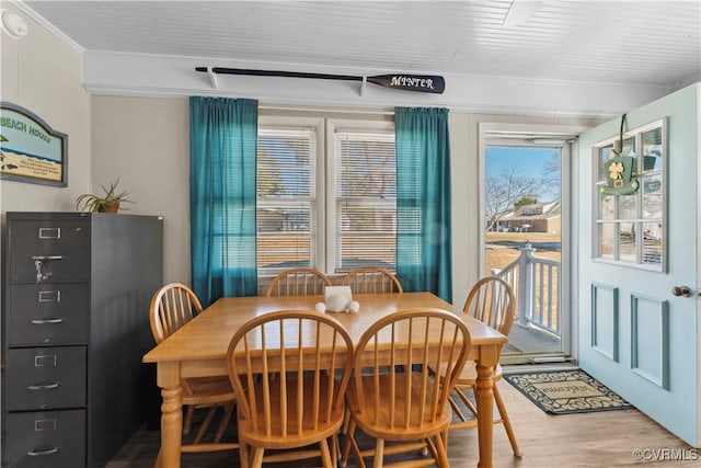 dining area with crown molding and wood finished floors