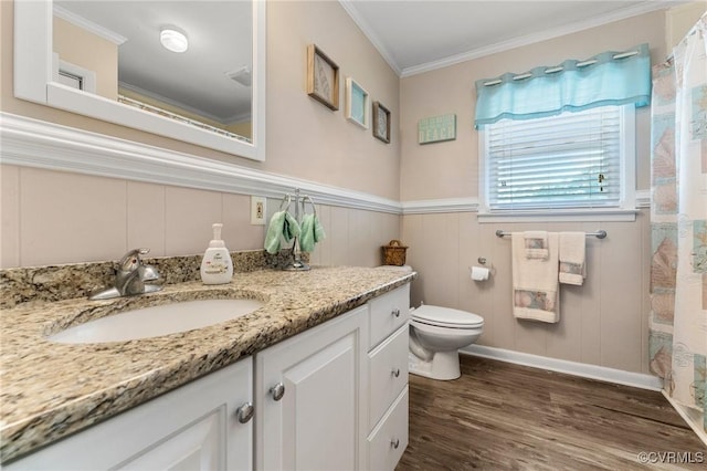 full bath with vanity, wood finished floors, wainscoting, crown molding, and toilet