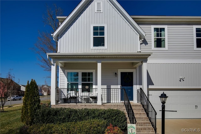 view of front of property with stairway, a porch, an attached garage, and board and batten siding