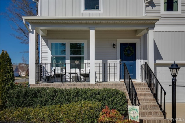 property entrance featuring a porch and a garage