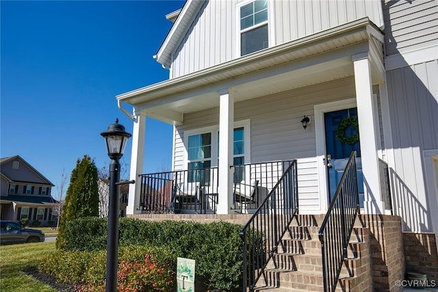 entrance to property with covered porch and board and batten siding