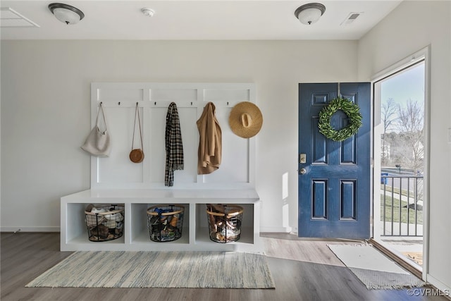 mudroom featuring visible vents, baseboards, and wood finished floors