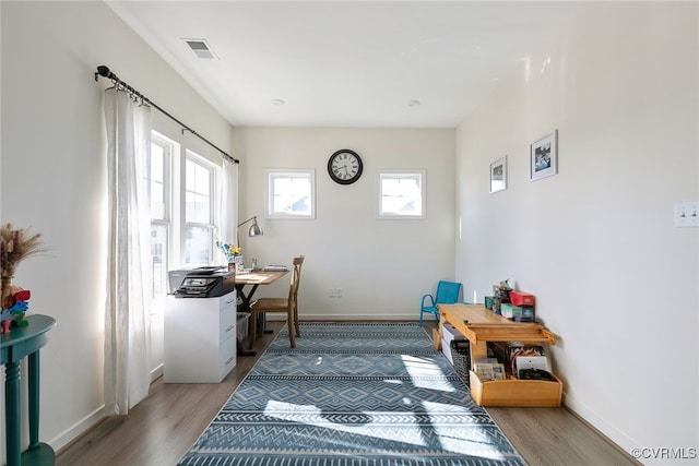 office area featuring visible vents, wood finished floors, and baseboards