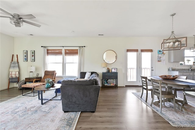 living room with plenty of natural light, wood finished floors, and visible vents