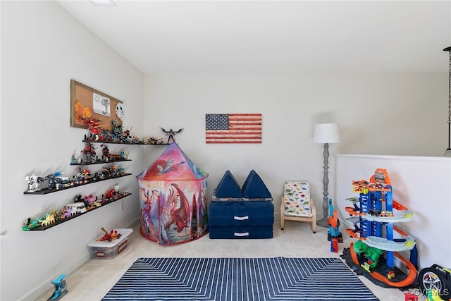 playroom featuring baseboards and carpet floors