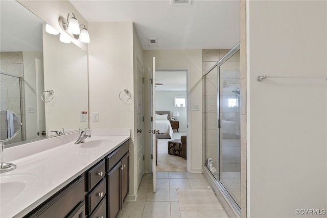 bathroom with visible vents, connected bathroom, a stall shower, tile patterned floors, and a sink