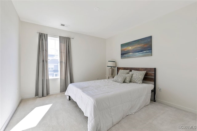 bedroom featuring visible vents, baseboards, and light colored carpet