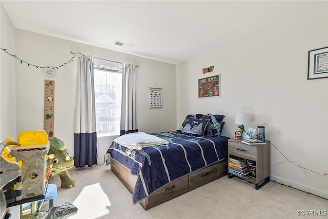 bedroom with carpet, visible vents, and baseboards