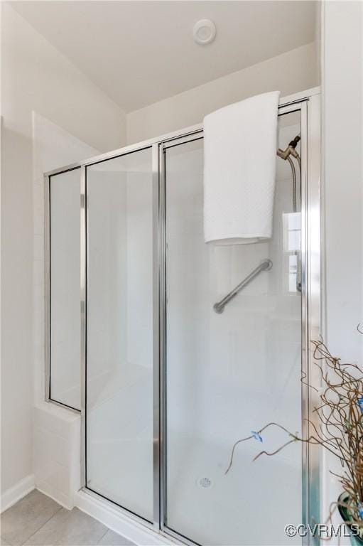 bathroom with tile patterned floors and a shower stall