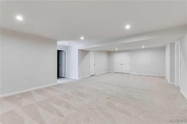 finished below grade area featuring recessed lighting, baseboards, and light carpet