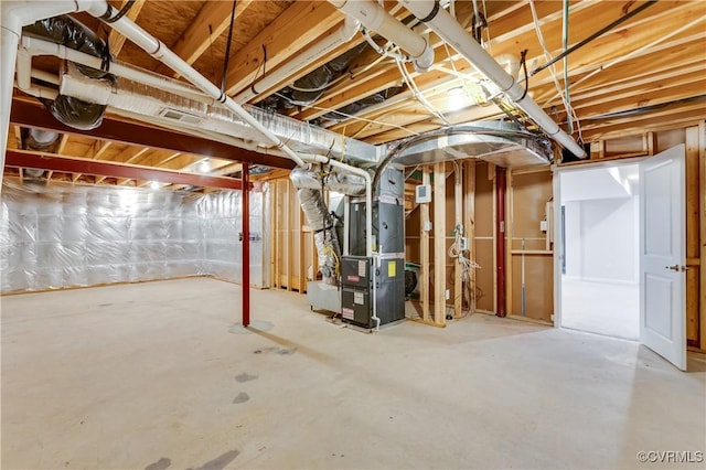 unfinished basement featuring heating unit