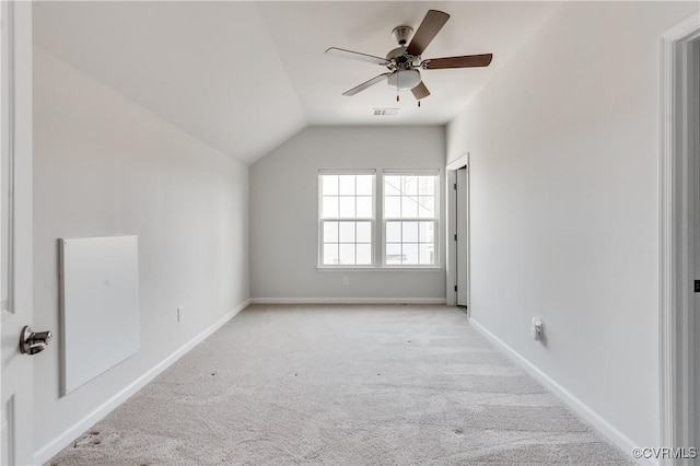 spare room with visible vents, baseboards, carpet floors, lofted ceiling, and ceiling fan