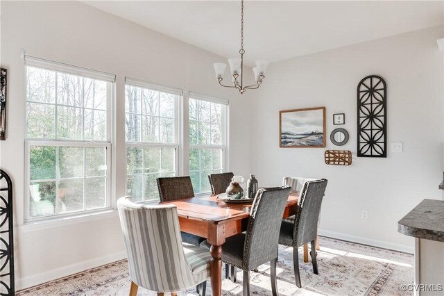 dining area featuring an inviting chandelier and baseboards