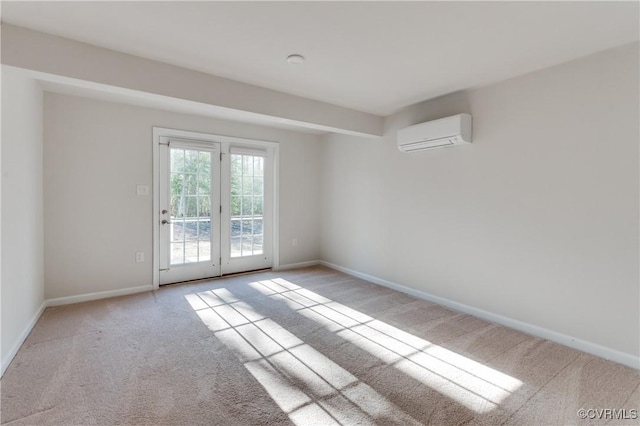 carpeted empty room with a wall unit AC and baseboards