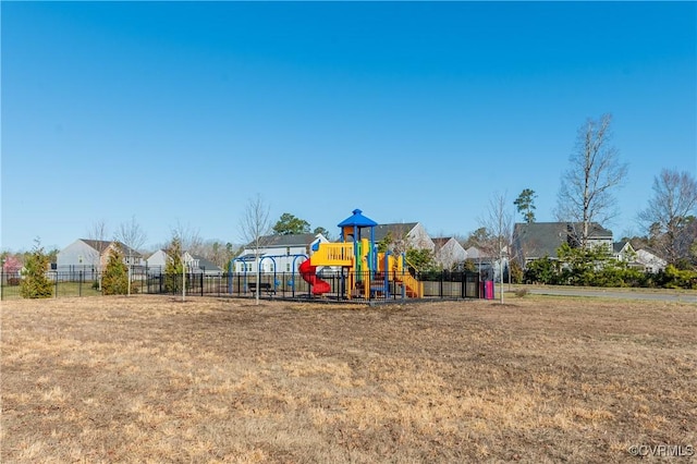 community playground featuring a yard and fence