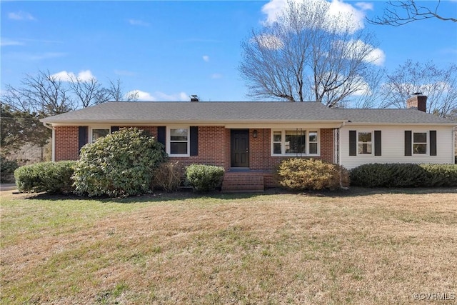 ranch-style home with brick siding, a chimney, a front lawn, and roof with shingles