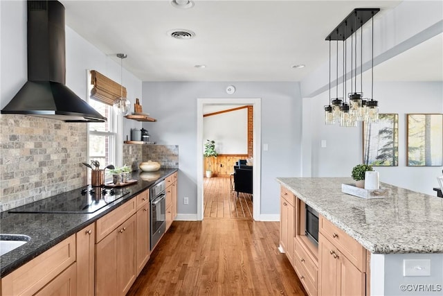 kitchen with visible vents, decorative backsplash, island exhaust hood, wood finished floors, and stainless steel appliances