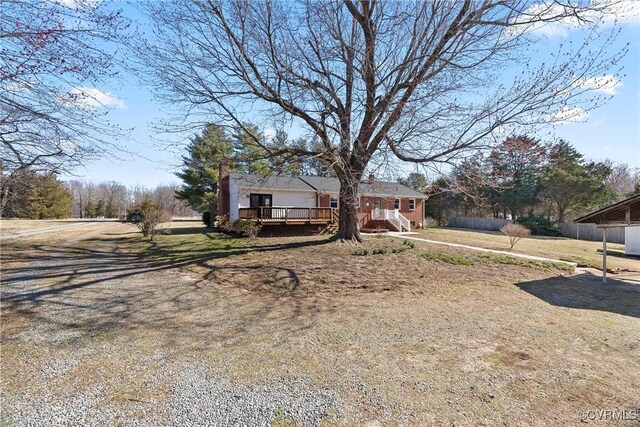 view of front of property featuring fence and a wooden deck