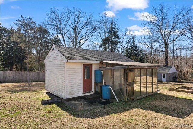 view of outbuilding with an outdoor structure and fence