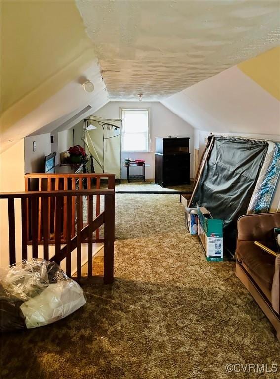 bonus room with carpet flooring and vaulted ceiling