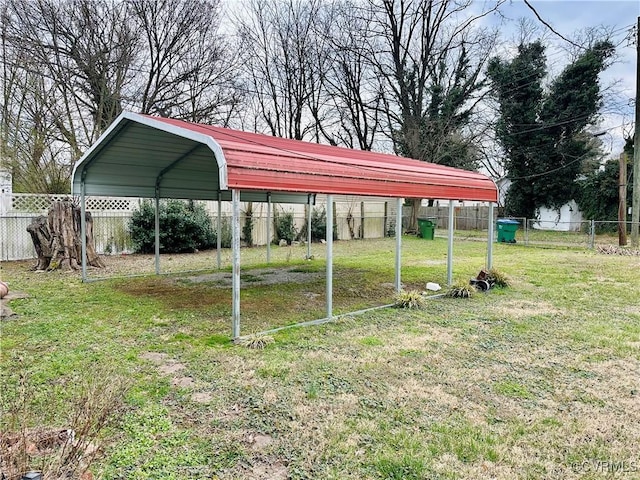 view of yard with a carport and fence