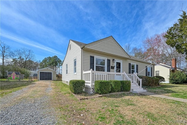 view of front of house with a detached garage, a front yard, an outdoor structure, crawl space, and driveway