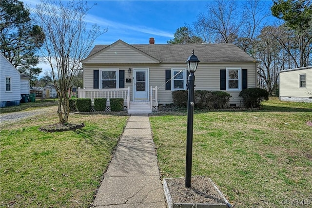 view of front of house featuring a chimney and a front yard