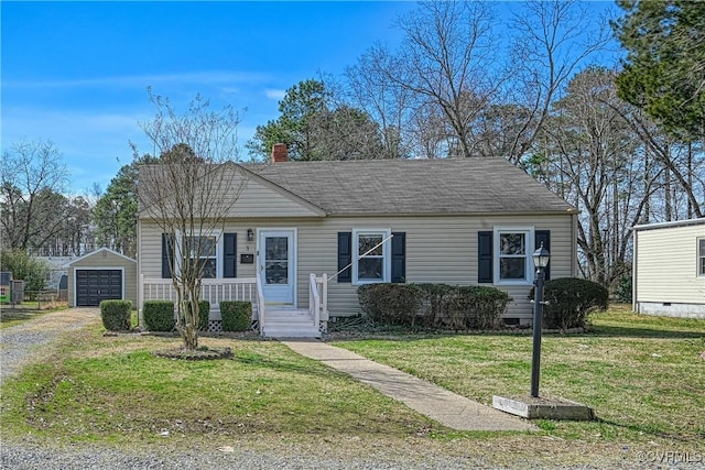 view of front facade with a detached garage, a front lawn, a chimney, an outdoor structure, and driveway