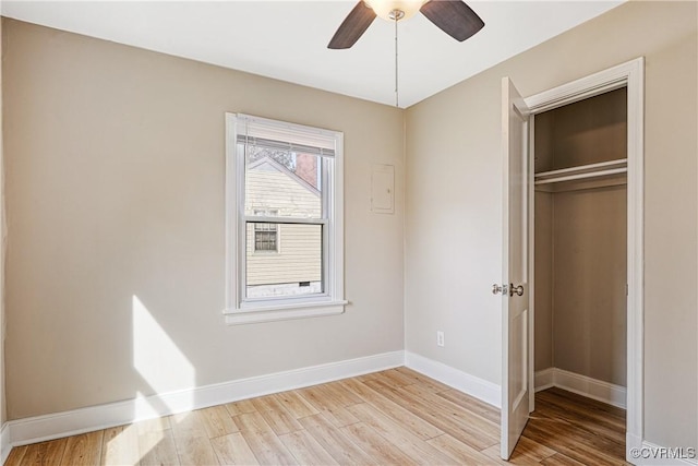 unfurnished bedroom featuring a closet, a ceiling fan, baseboards, and light wood finished floors