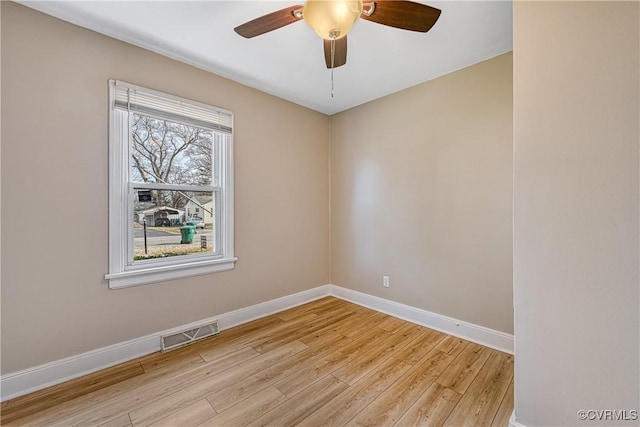 spare room with visible vents, baseboards, ceiling fan, and light wood finished floors