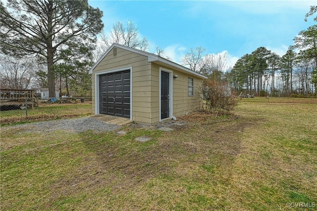 detached garage with fence and driveway