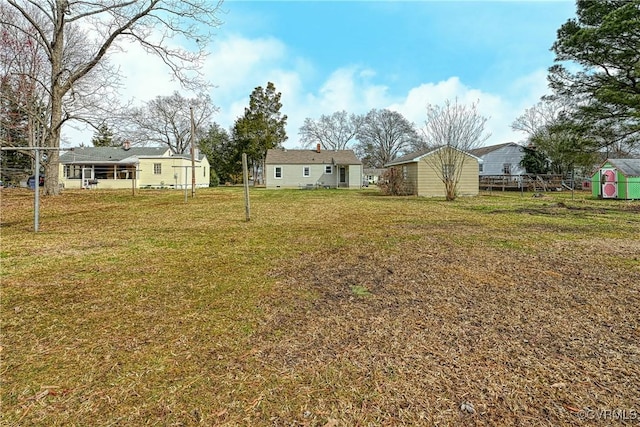 view of yard featuring an outdoor structure and a shed