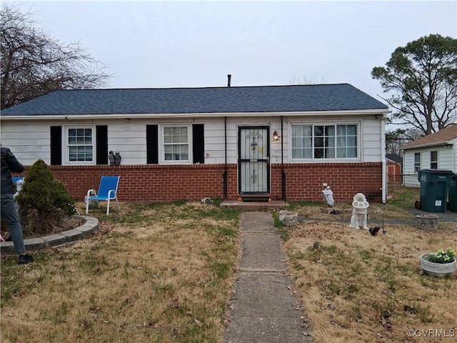 view of front of house featuring brick siding and a shingled roof