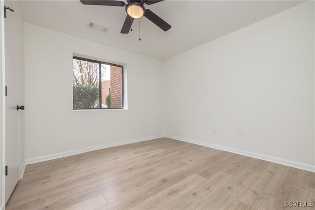 spare room with a ceiling fan, baseboards, visible vents, and light wood-type flooring