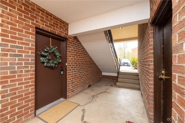 doorway to property with brick siding