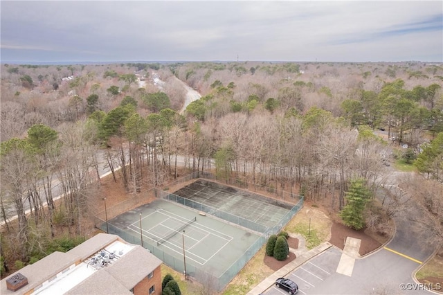 bird's eye view with a wooded view