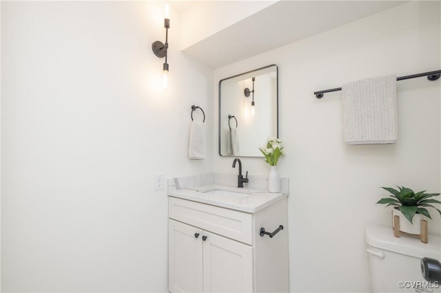 bathroom featuring toilet and vanity