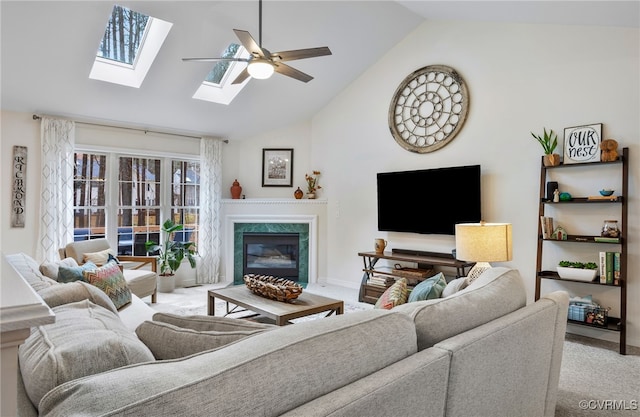 living area with baseboards, light colored carpet, a premium fireplace, high vaulted ceiling, and a ceiling fan