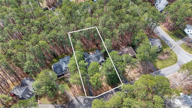 drone / aerial view featuring a forest view