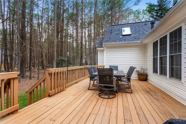 wooden terrace with outdoor dining space