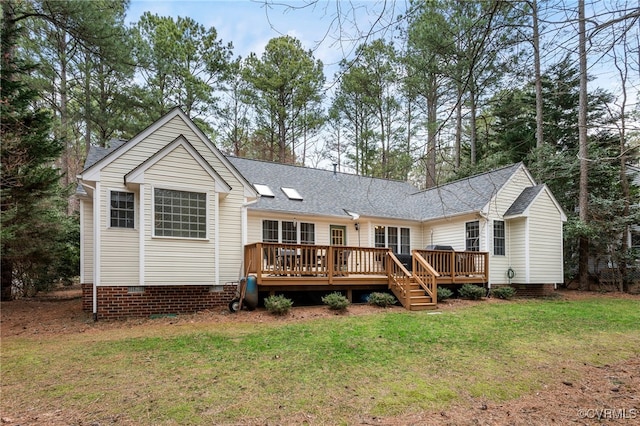 rear view of house featuring crawl space, a lawn, a wooden deck, and a shingled roof