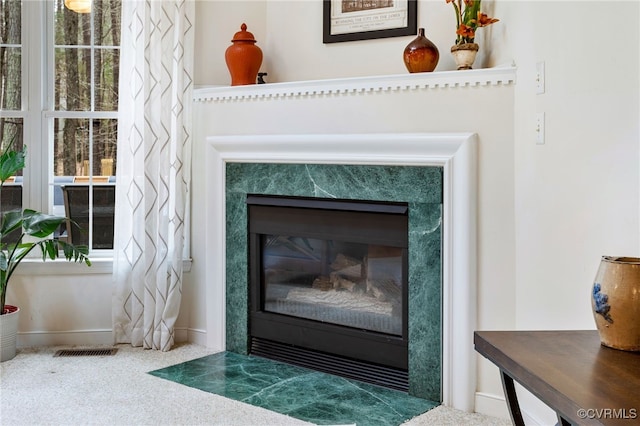 details with carpet, a fireplace, visible vents, and baseboards