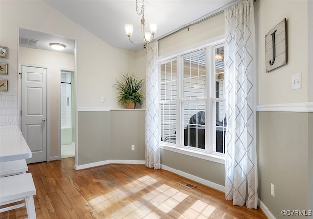 interior space with visible vents, plenty of natural light, and wood finished floors