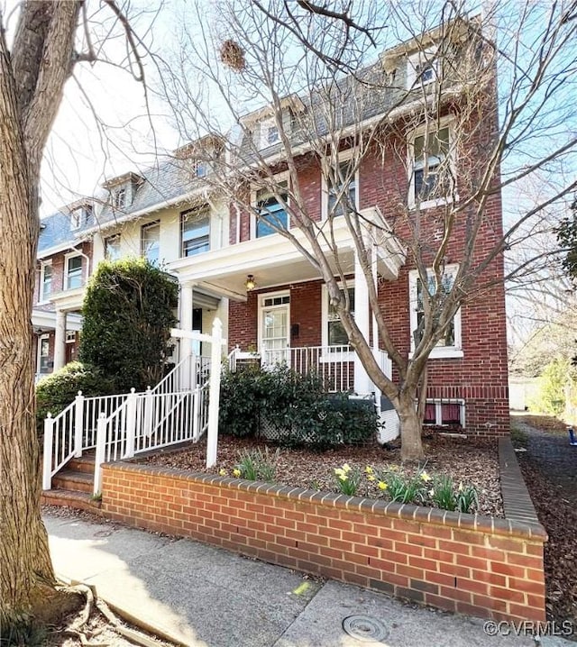 view of front of property with brick siding and covered porch