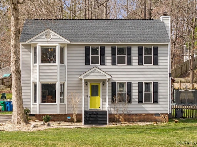 view of front of house featuring a chimney, entry steps, a front lawn, crawl space, and a trampoline