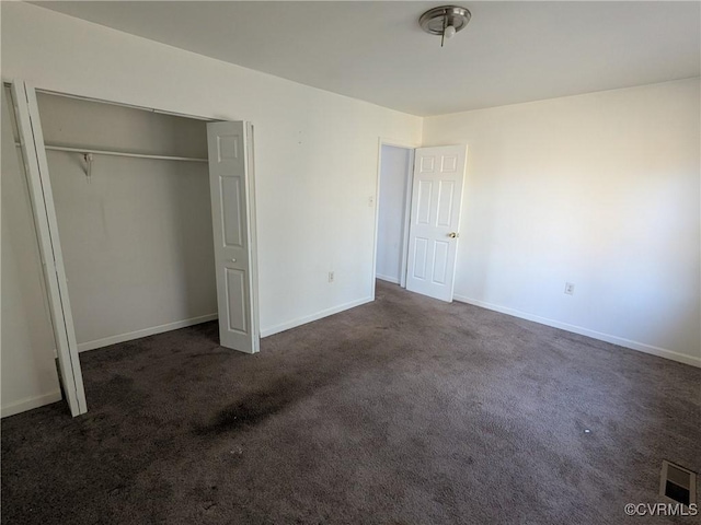 unfurnished bedroom featuring a closet, visible vents, baseboards, and carpet