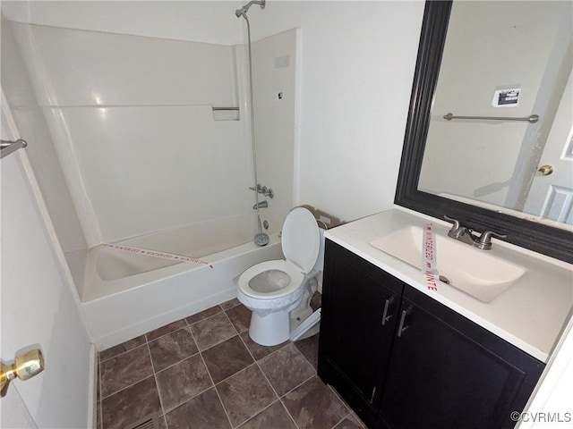 bathroom featuring vanity, toilet, and shower / bathing tub combination